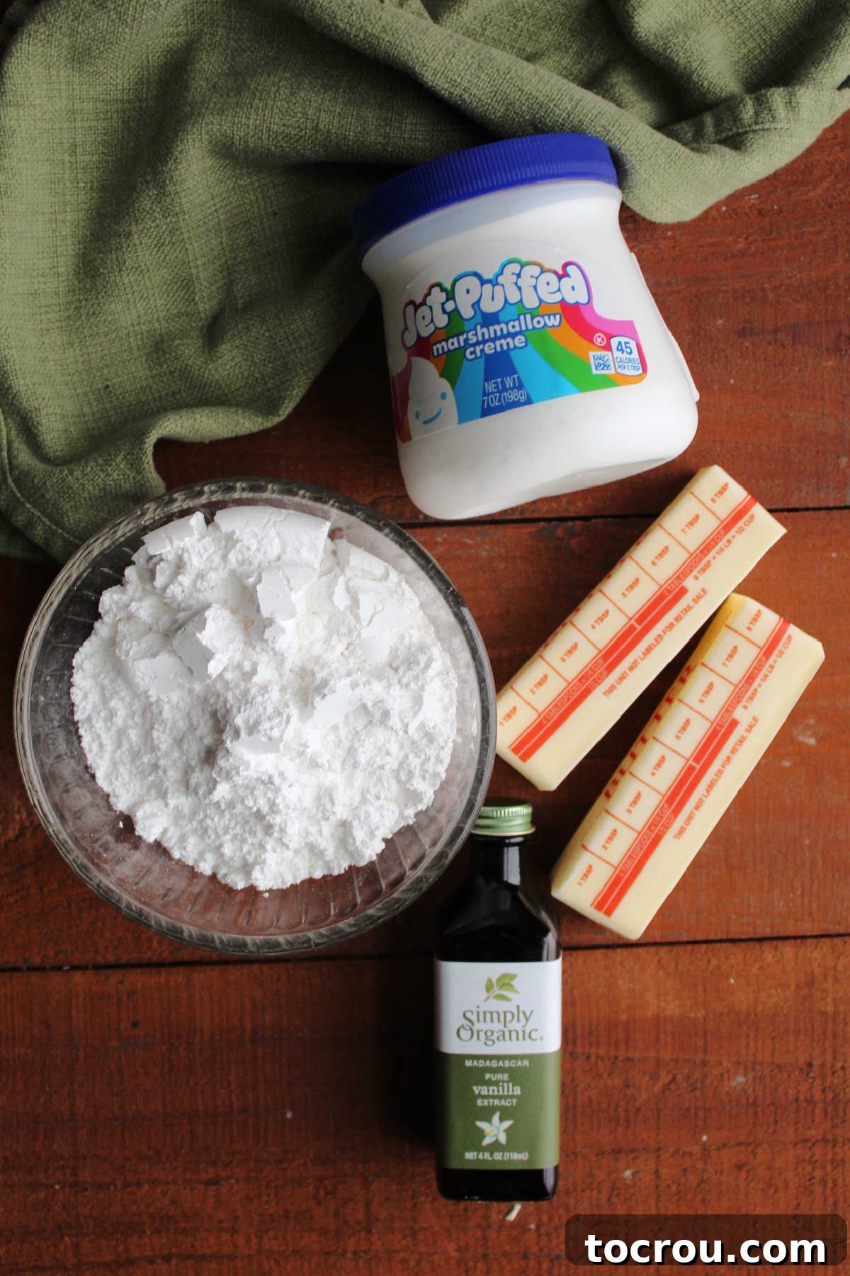 Ingredients for marshmallow fluff buttercream including butter, vanilla, powdered sugar, and marshmallow fluff.