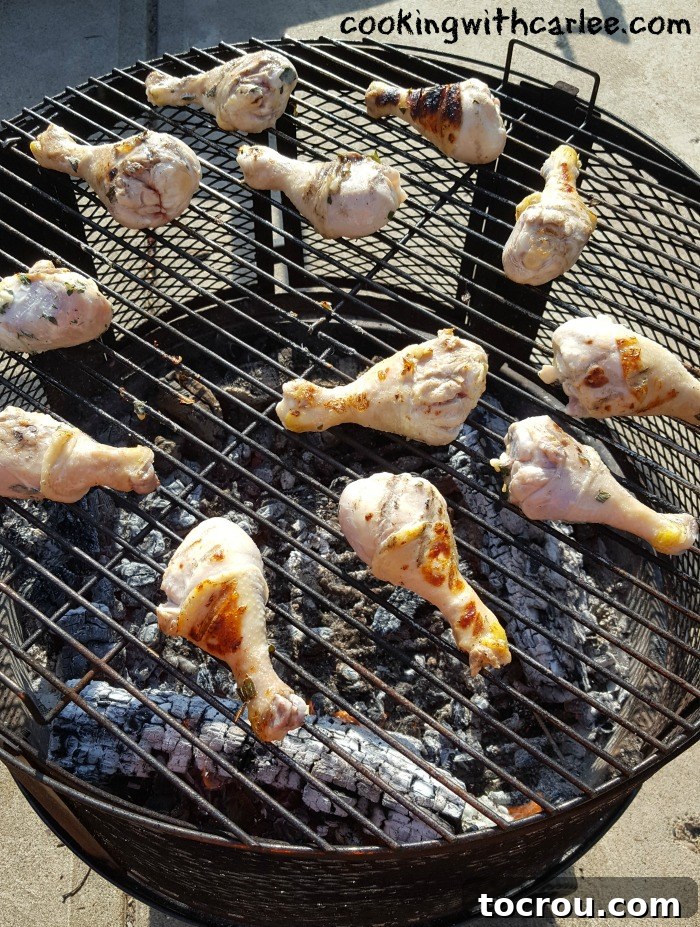 Chicken Drumsticks Grilling to Perfection Close-up view of several chicken drumsticks grilling over an open wood fire, perfectly charring and developing crispy skin.