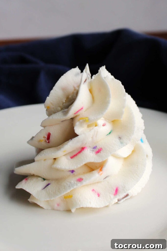 Piped swirl of funfetti frosting.