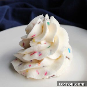 Swirl of buttercream frosting with colorful sprinkles throughout.