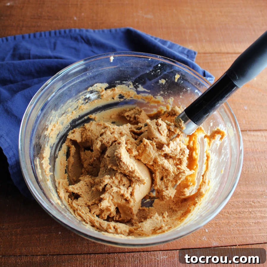 Decadent Chocolate Peanut Butter Pretzel Treats 6 A bowl filled with freshly mixed, smooth peanut butter filling, perfectly textured and ready to be used in the pretzel bites.