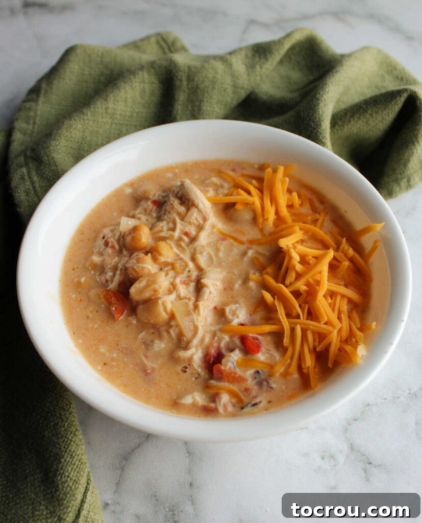 Buffalo Chicken Chili with Cheddar Cheese Bowl of creamy buffalo chicken soup topped with shredded cheddar cheese.