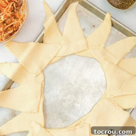 Second layer of crescent dough triangles placed over first layer, offset slightly to make wreath.