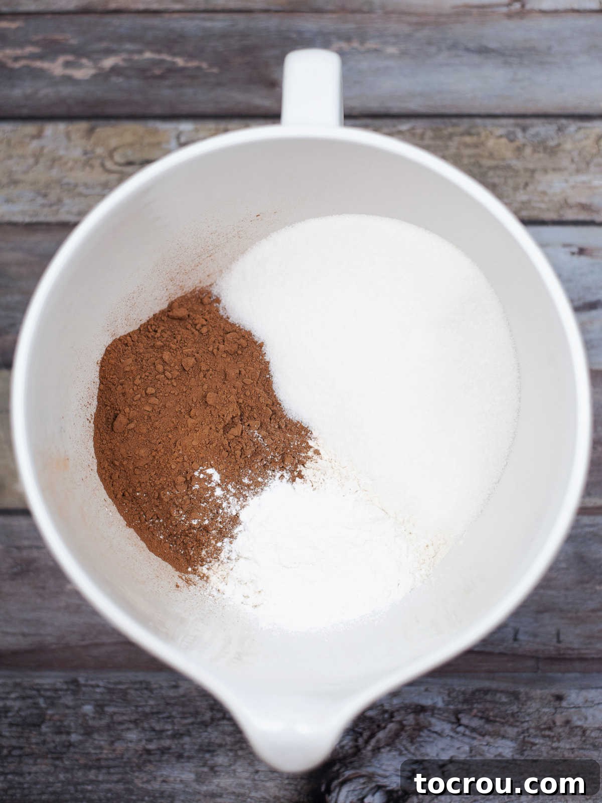 Bowl of flour, sugar, cocoa powder etc. ready to be stirred into cake mix.