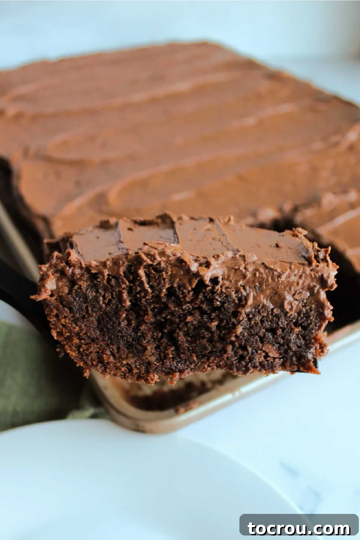 First Slice of Brownie Lifting out first piece of lunch lady brownies from sheet pan.