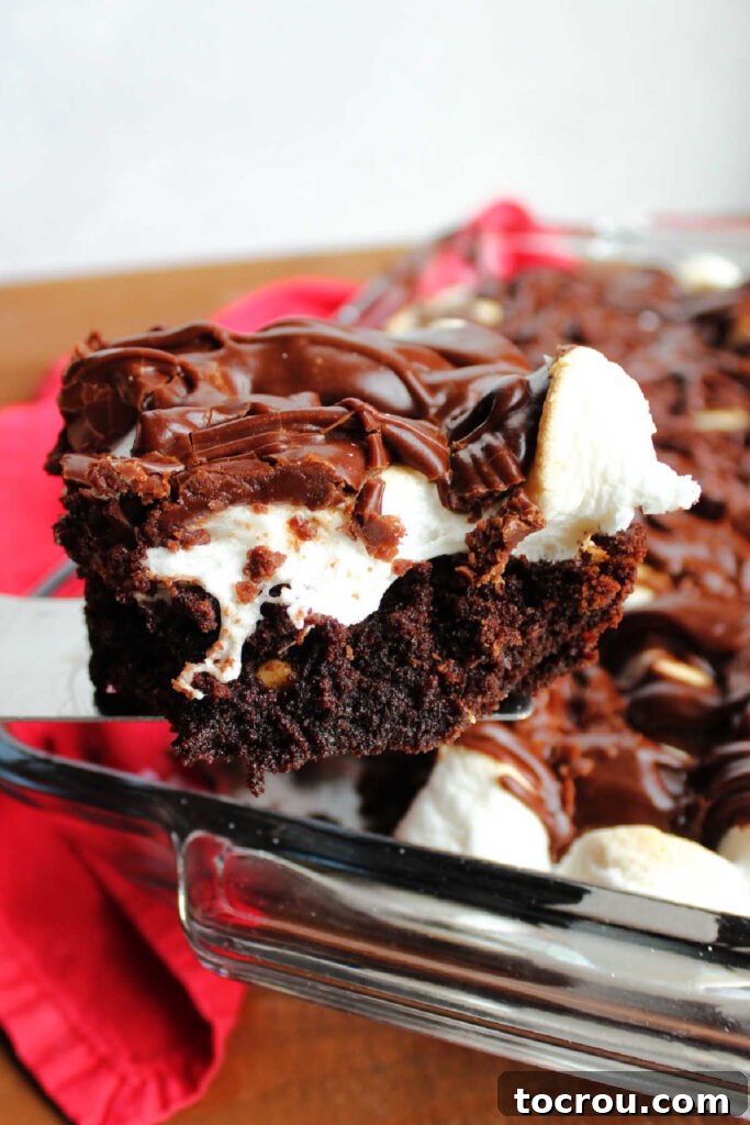 Lifting piece of mississippi mud brownie out of pan.