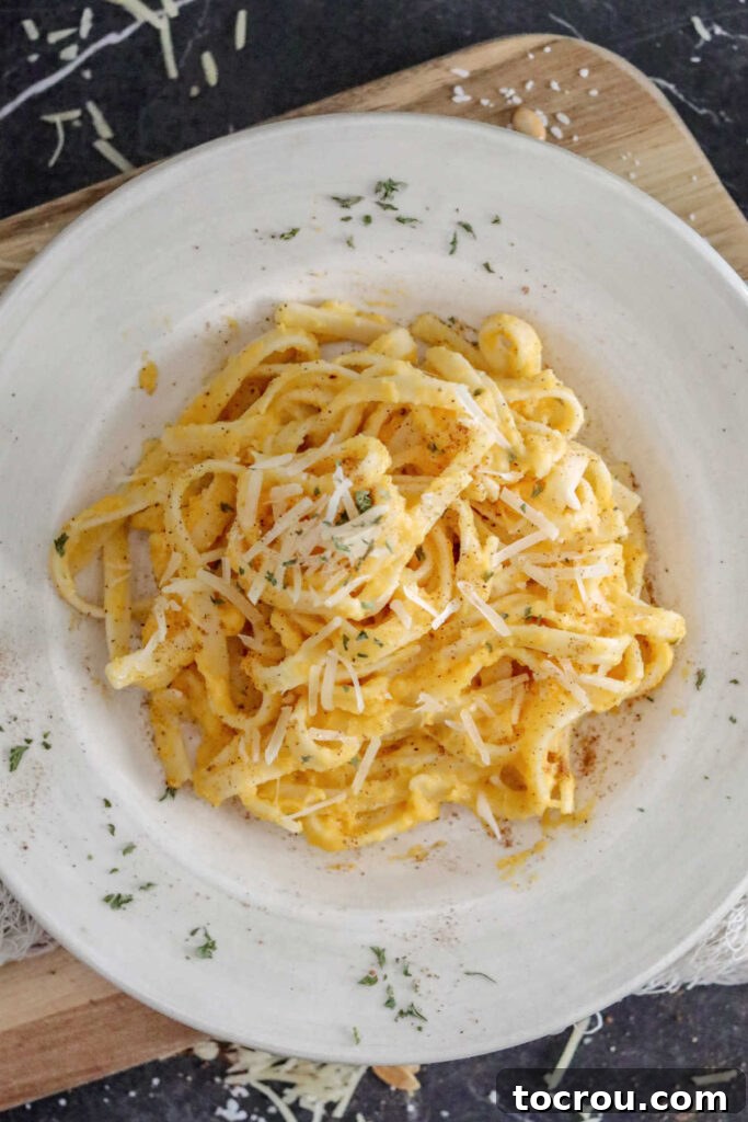 Looking down on a generous serving of creamy butternut squash alfredo pasta, invitingly ready to be enjoyed.
