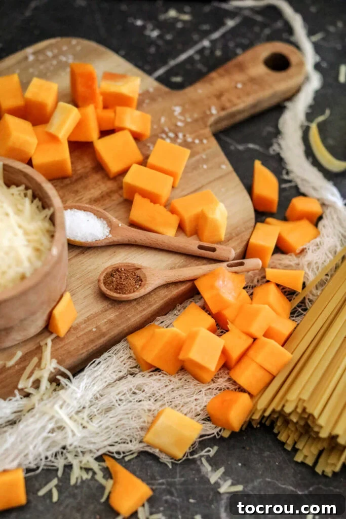 Neatly chopped chunks of raw butternut squash, perfectly prepped and ready for cooking.