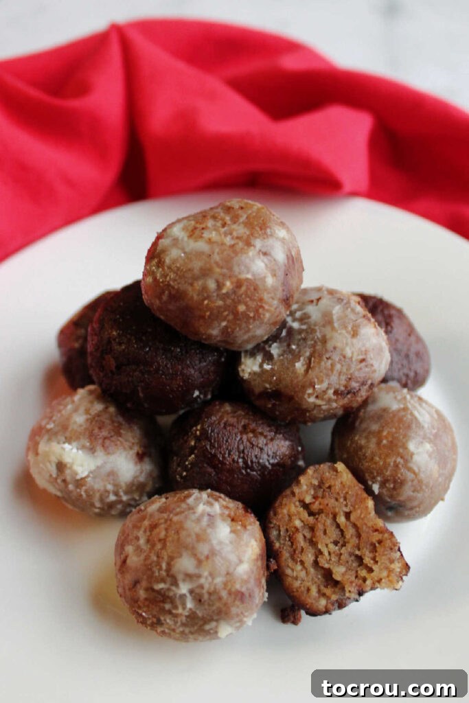 Kentucky Bourbon Pecan Truffles 3 Stack of bourbon balls with one cut in half showing the moist, crumbly center, revealing the texture within.