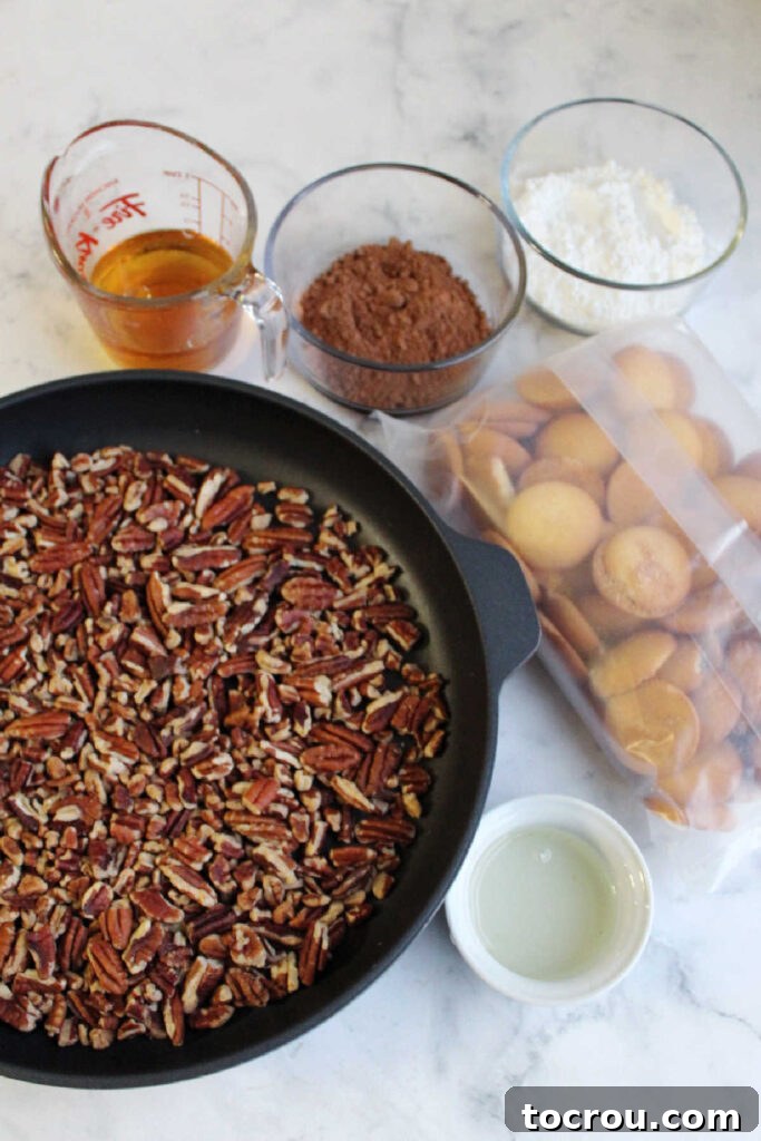 Kentucky Bourbon Pecan Truffles 5 All the essential ingredients for making bourbon balls laid out neatly: fresh pecan pieces, a box of vanilla wafers, a bottle of bourbon, and light corn syrup.