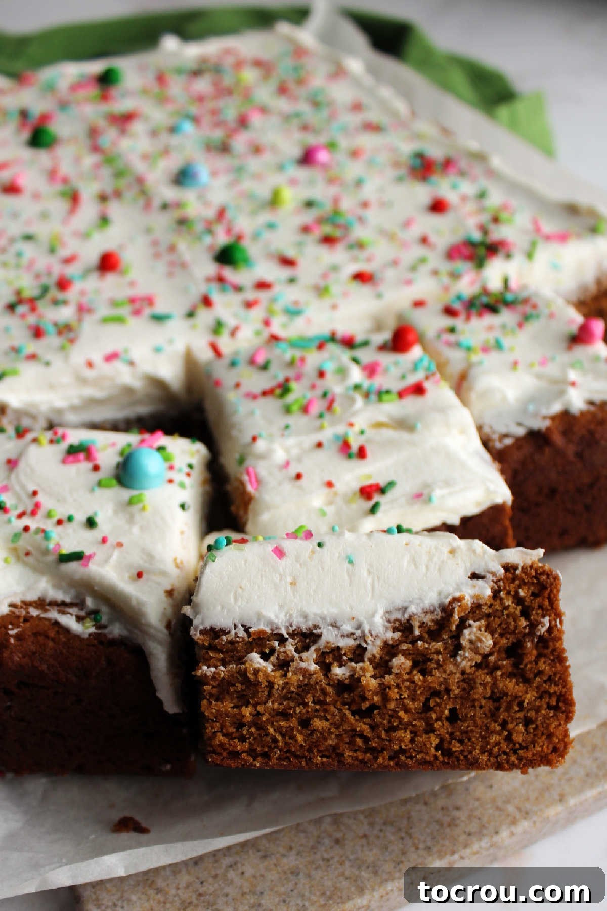 Several neatly cut squares of gingerbread cookie bars, ready to be served or enjoyed, showcasing their soft interior and frosted tops.