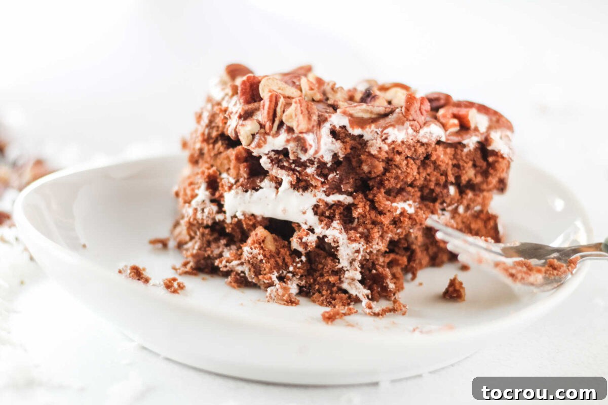 Bite out of mudslide cake with chocolate, marshmallow fluff, pecans and coconut.