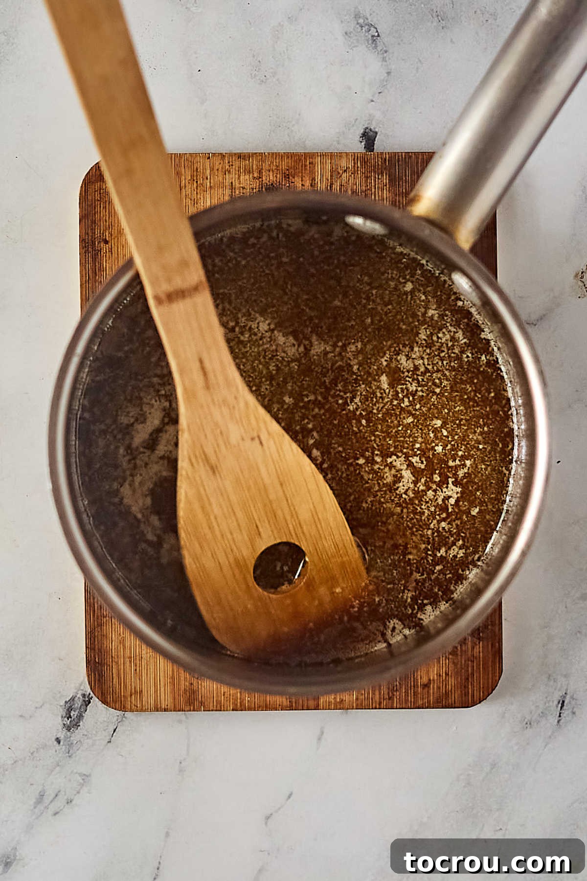 Caramel Base Boiling Saucepan with boiled butter, brown sugar, and corn syrup mixture. The caramel base for the Crispix mix.