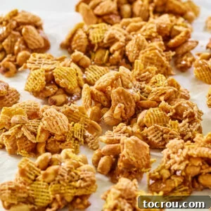 Caramel Crispix Mix Recipe Image Caramel Crispix mix with peanuts broken into pieces, ready to eat. A close-up of the delicious snack.