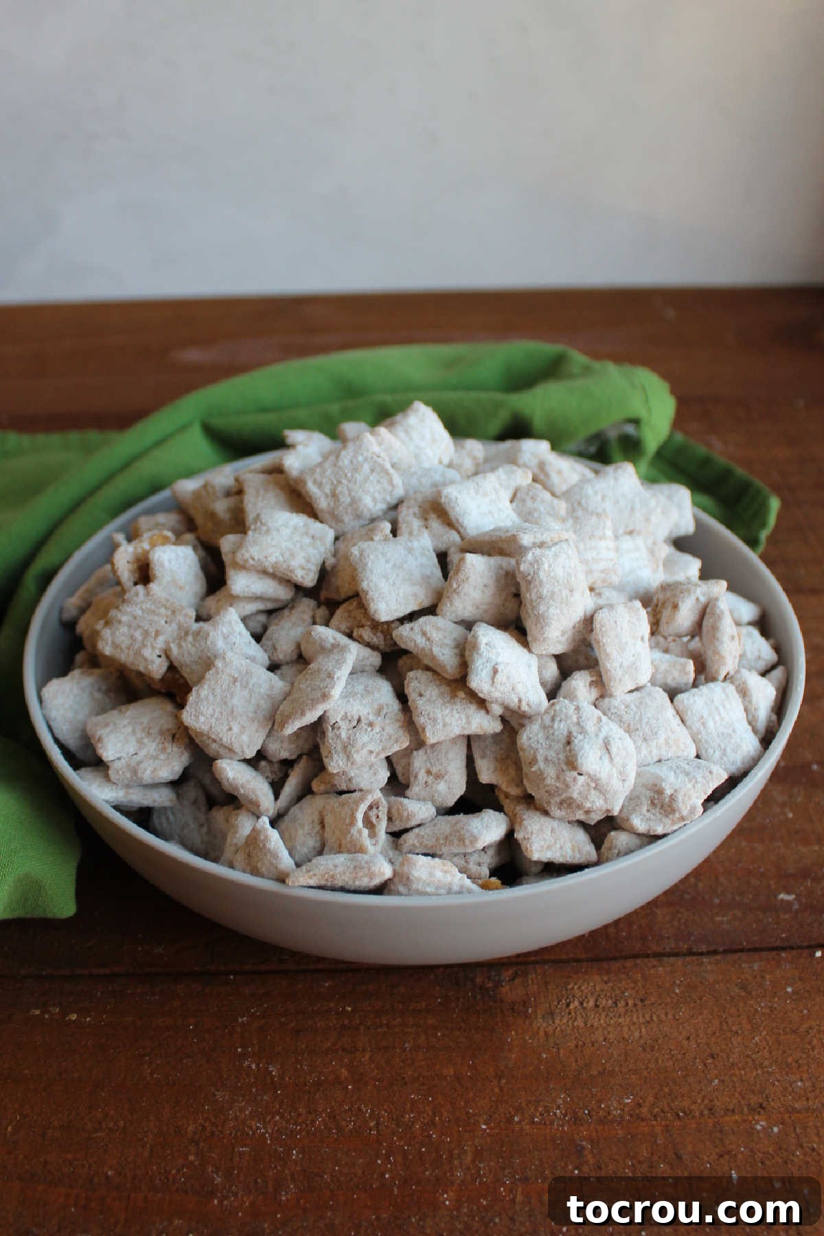 Serving bowl filled with maple cinnamon muddy buddies ready to eat.