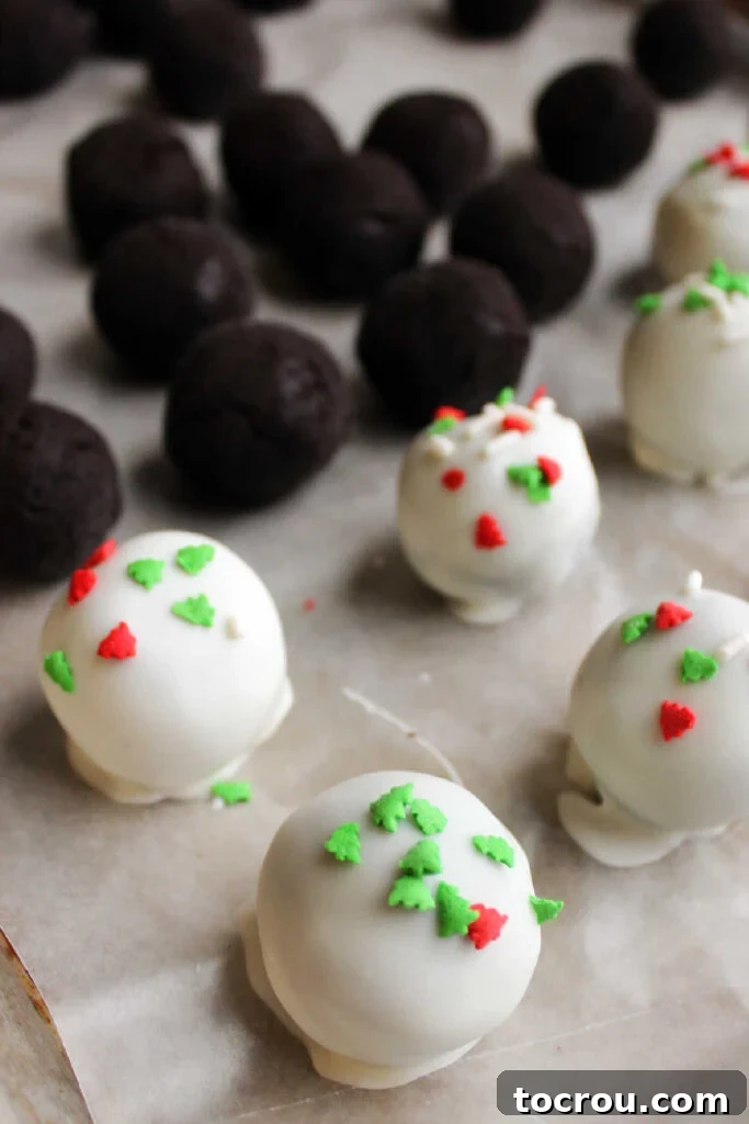 Creamy No-Bake Oreo Truffles 6 Dipping Oreo balls into melted white chocolate and adding sprinkles.