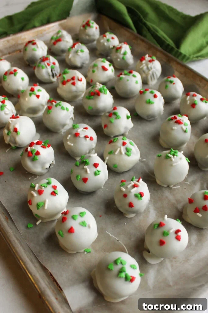 Creamy No-Bake Oreo Truffles 7 Tray of freshly dipped condensed milk Oreo truffles dipped in white chocolate setting up.