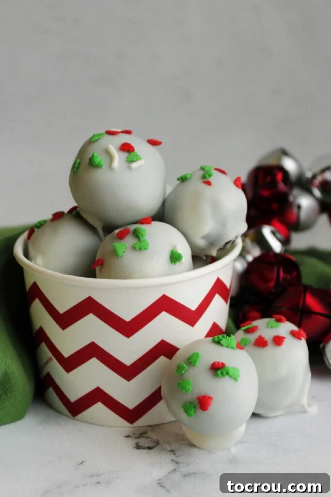 Creamy No-Bake Oreo Truffles 9 Cup of white chocolate coated Oreo balls topped with festive Christmas sprinkles.