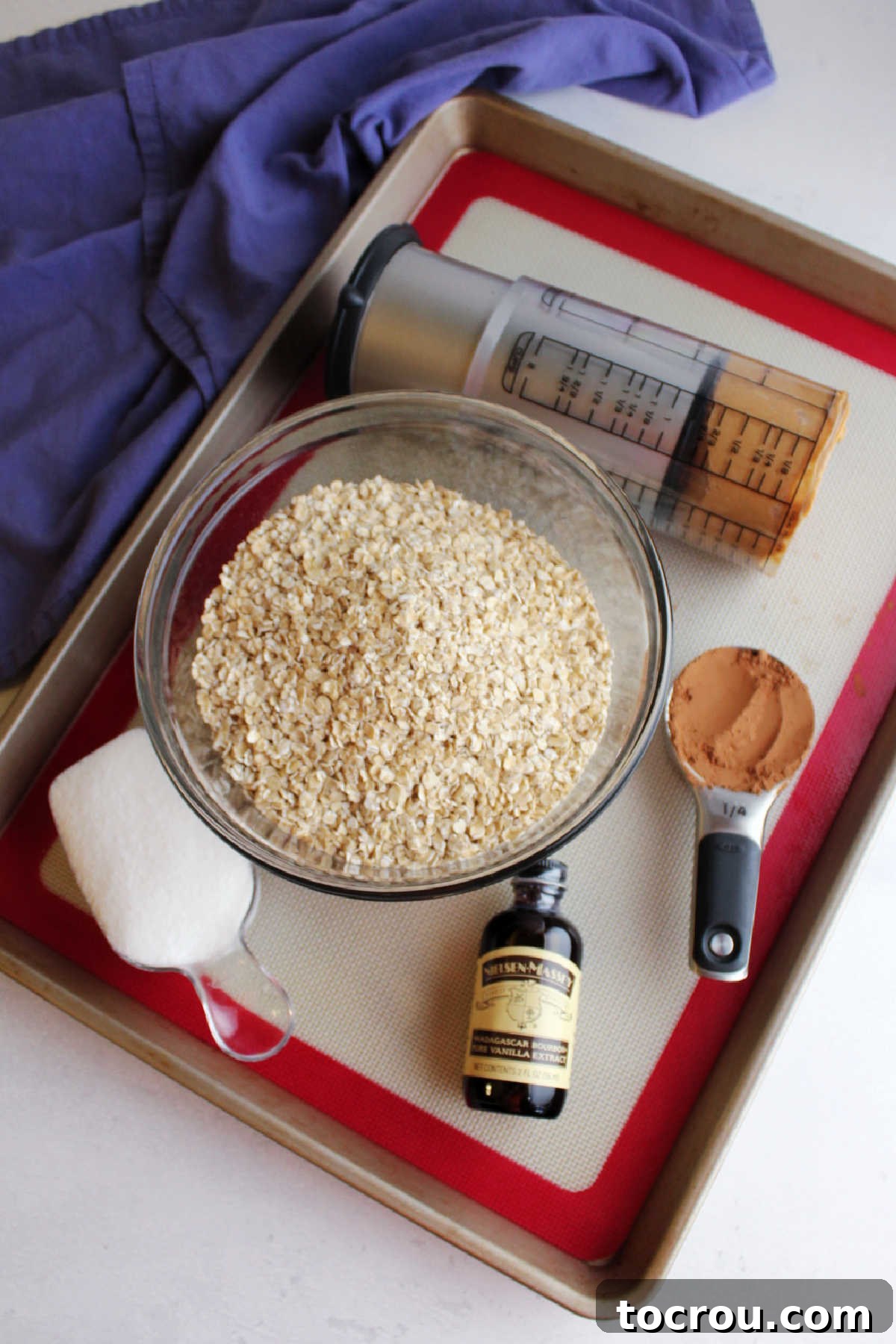 Chocolate Peanut Butter No-Bake Oatmeal Delights 2 Ingredients including oats, peanut butter sugar, cocoa powder, vanilla ready to be made into cookies.