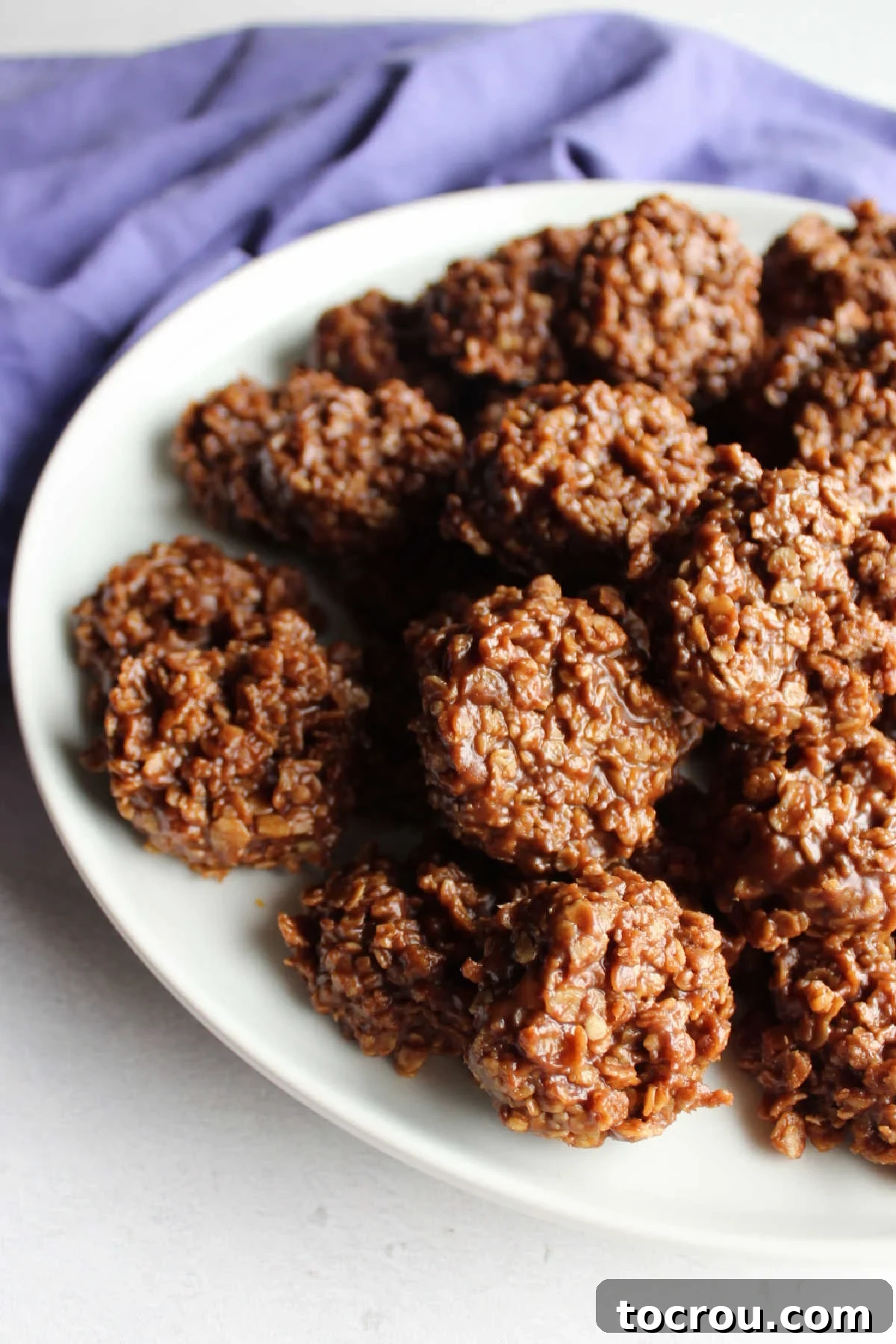 Chocolate Peanut Butter No-Bake Oatmeal Delights 6 Serving plate pile high with peanut butter chocolate no bake oatmeal cookies.