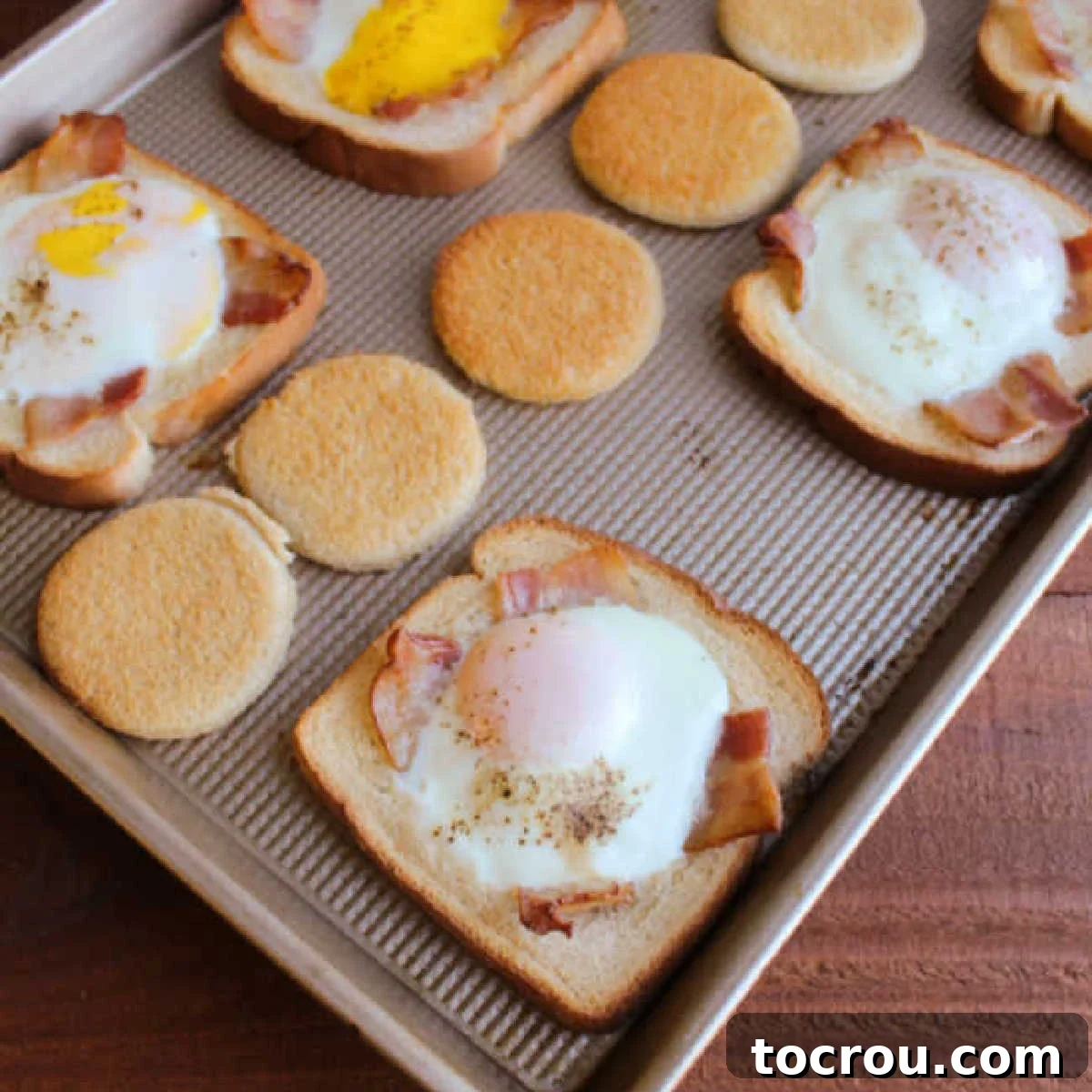 Sheet Pan Bacon and Egg in a Basket: The Ultimate Family Breakfast Golden brown toast with eggs cooked in the middle, topped with crispy bacon, all served fresh from a sheet pan.