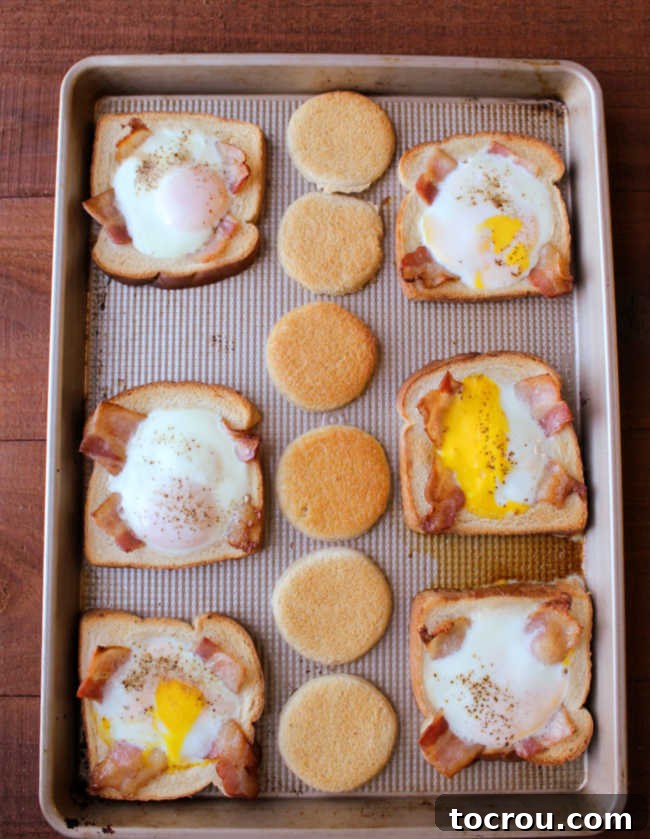 Freshly Baked Sheet Pan Eggs in a Basket Cooked sheet pan eggs in a basket with bacon strips and golden brown toast circles, beautifully arranged and ready to serve.
