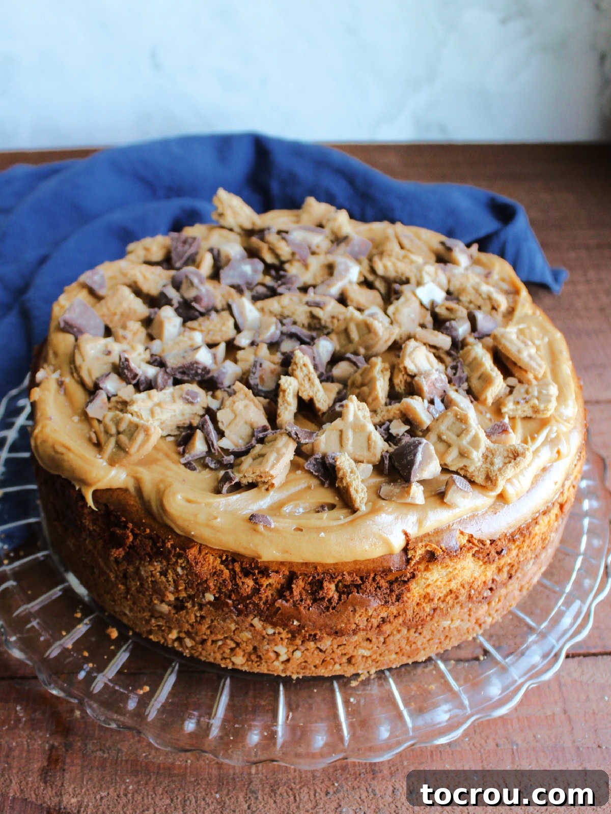 Completed Peanut Butter Toffee Cheesecake Full peanut butter toffee cheesecake topped with peanut butter whipped cream, chunks of Nutter butter cookies, and bits of heath bars.