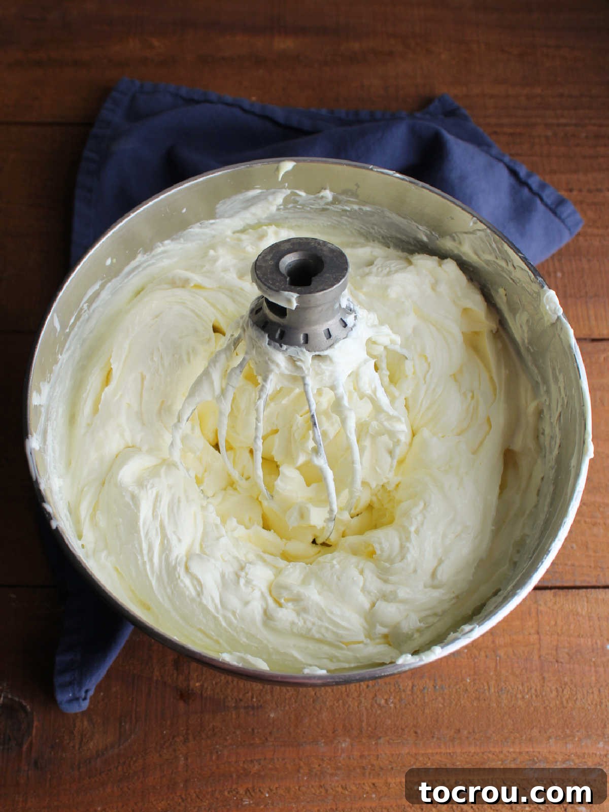 Quick Lemon Berry Jar Cheesecakes 6 Mixer bowl filled with fluffy lemon no bake cheesecake mixture and the whisk attachment from the mixer.