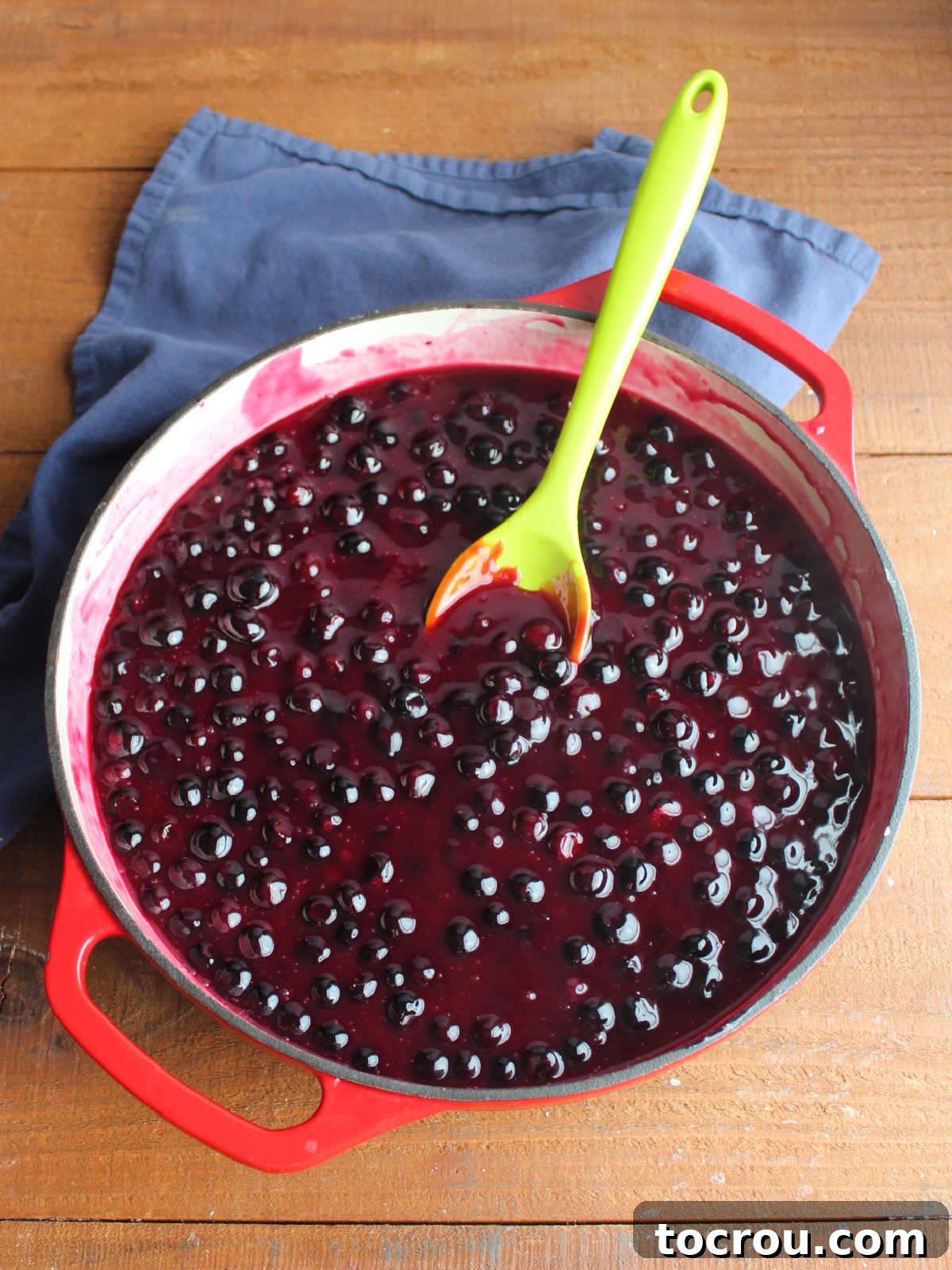 Quick Lemon Berry Jar Cheesecakes 8 Cast iron braiser with thicken blueberry sauce in it after the berries have been cooked down with a little bit of water and lemon juice.