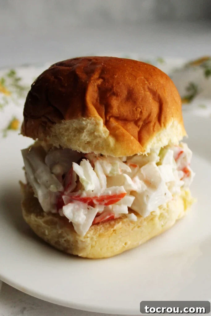 Kani Salad 4 Sandwich made with crab salad in a golden Hawaiian sweet roll ready to eat.