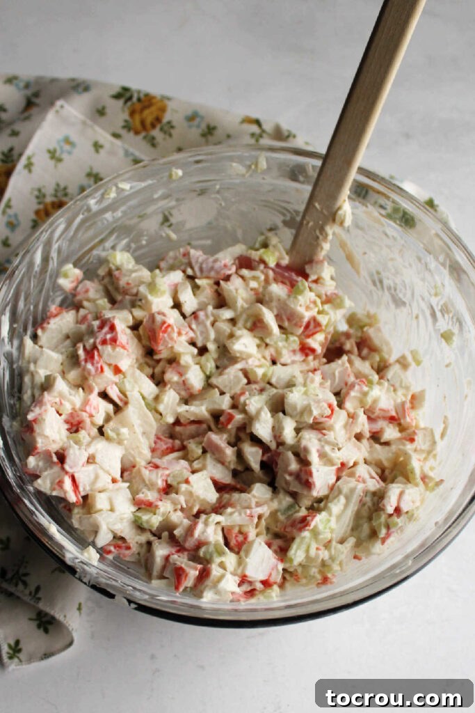 Kani Salad 8 Mixing bowl filled with freshly made crab salad.