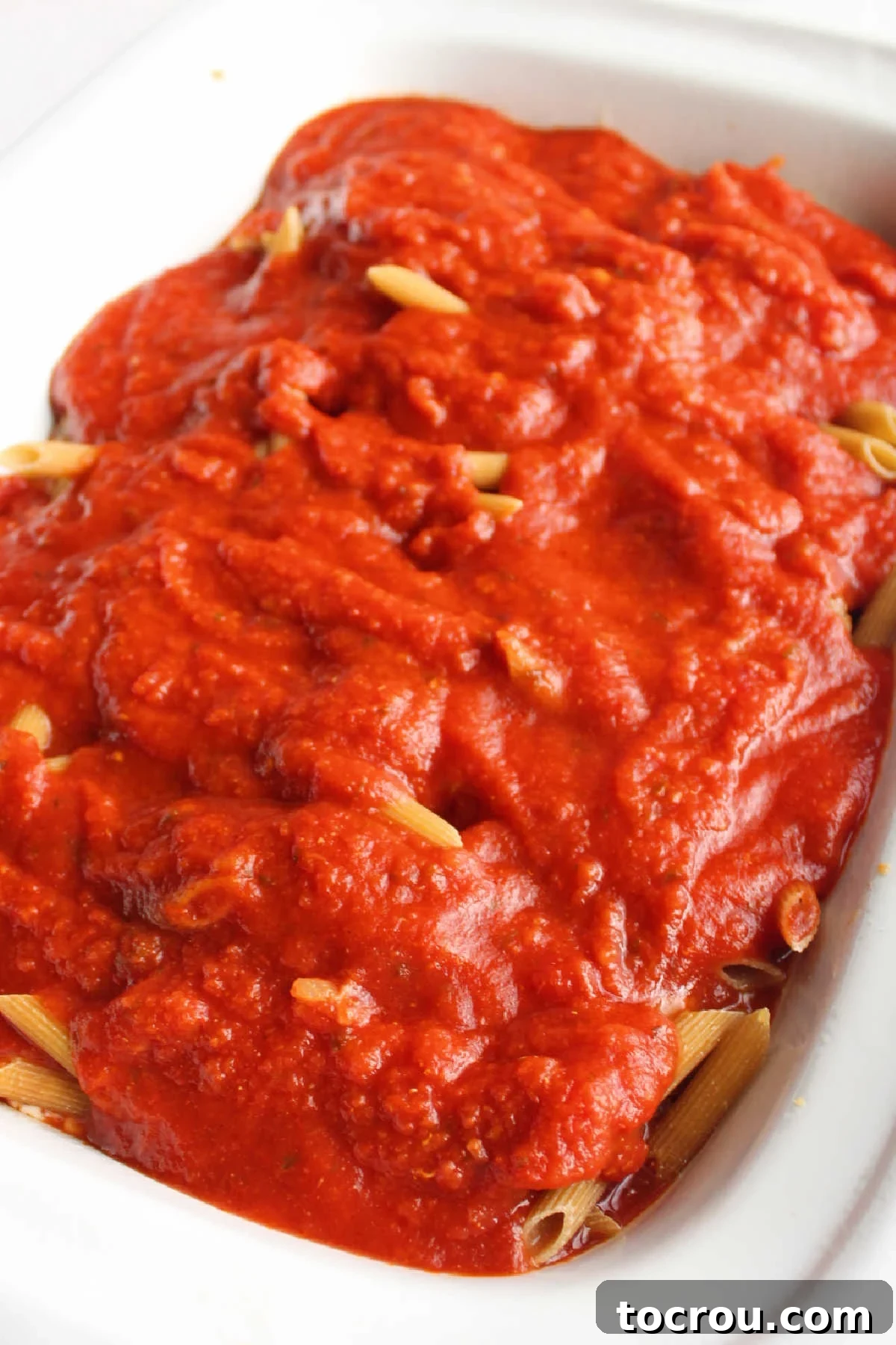 Pasta sauce over raw pasta in slow cooker.