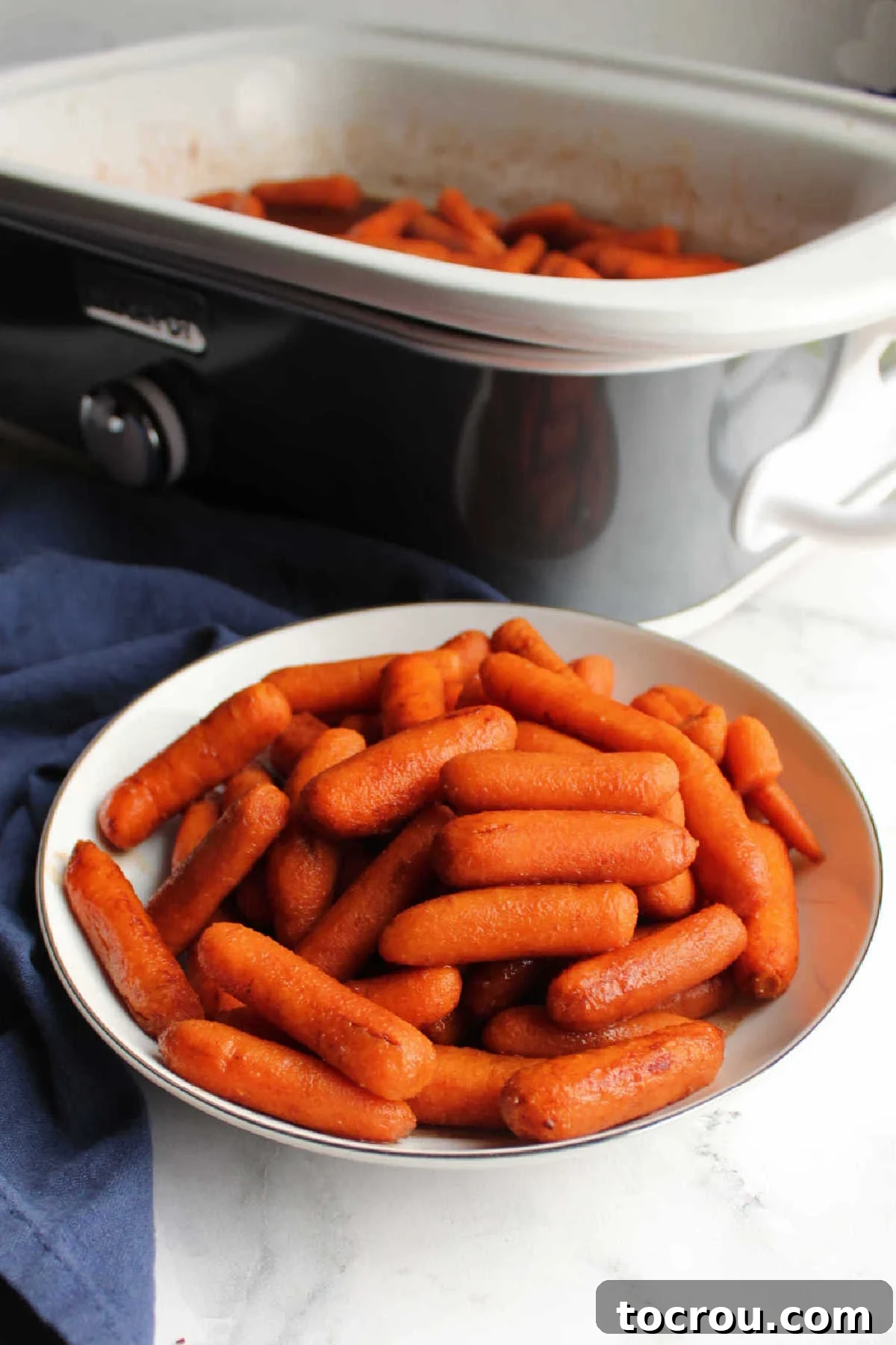 Serving cinnamon and honey glazed carrots directly from a slow cooker.