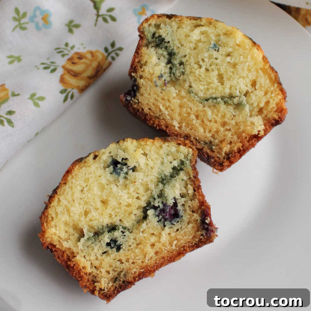 Moist Blueberry Sour Cream Muffin Interior Inside of a soft blueberry muffin showing its moist crumb and abundant blueberries.