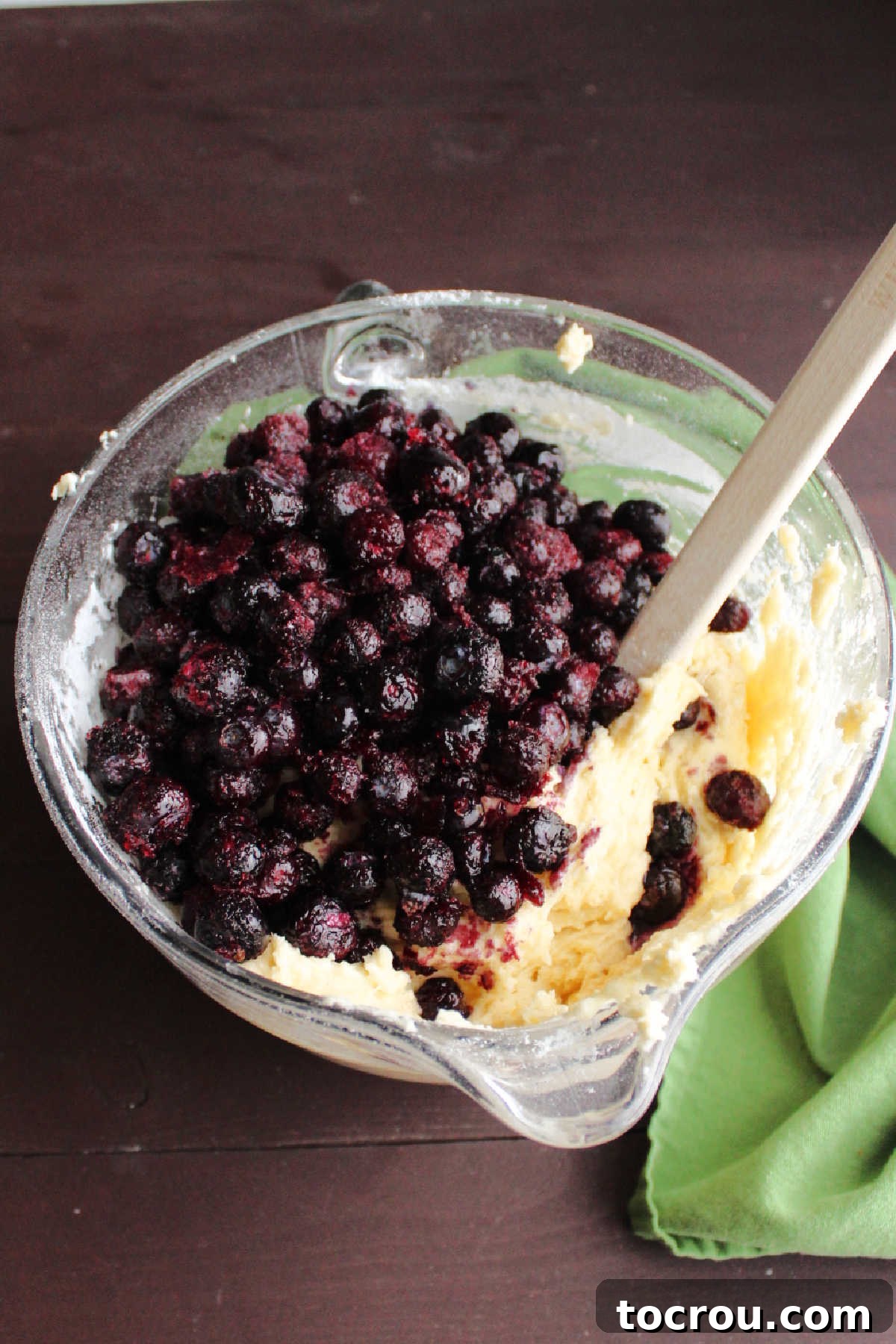 Muffin Batter with Blueberries Mixing bowl with blueberry muffin batter and fresh blueberries.