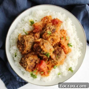 A beautifully presented bowl of rice topped with hearty porcupine meatballs, generously covered in the delicious secret ingredient sauce. A perfect family meal.