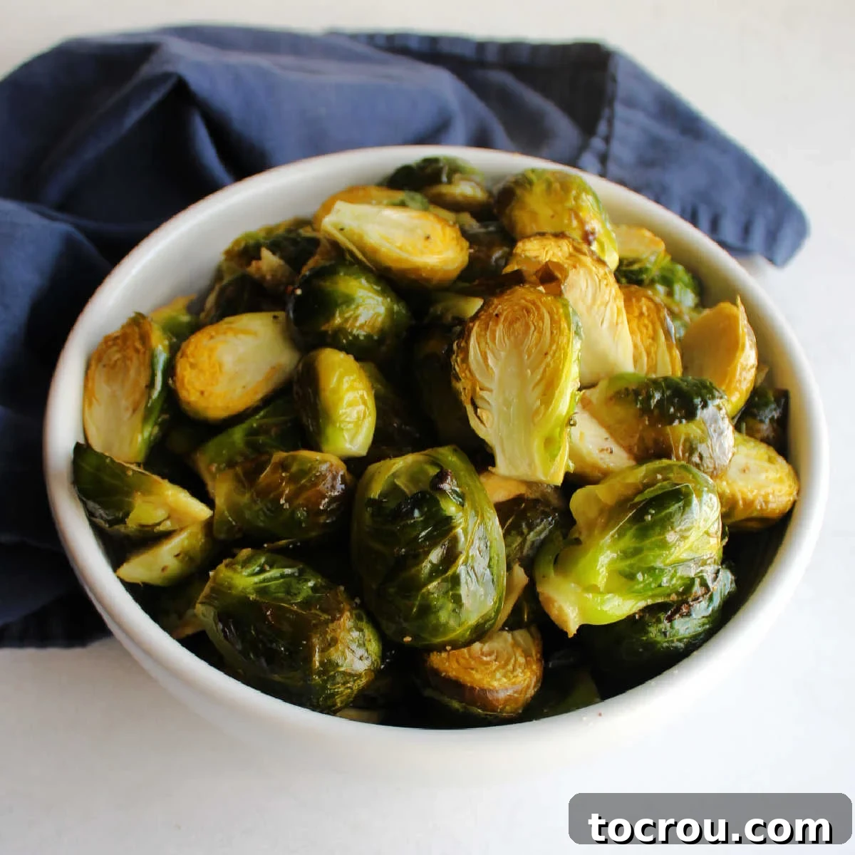 Bowl of roasted brussels sprout halves ready to serve. 