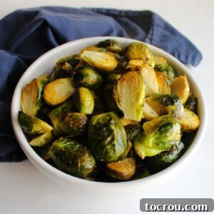 Bowl of roasted brussels sprout halves ready to serve.