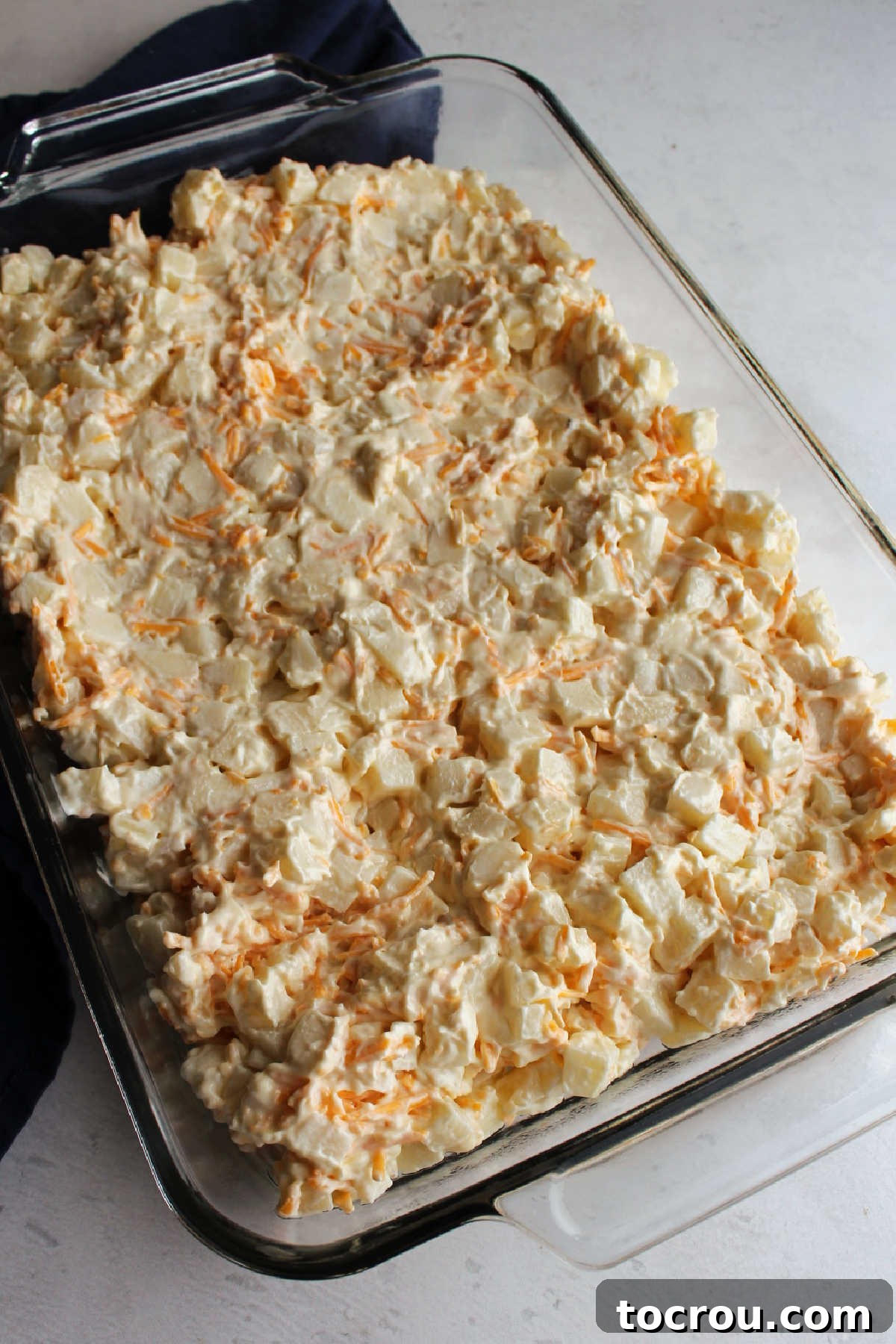 Casserole Ready for Topping Potato, ranch and cheese mixture in 9x13 pan.