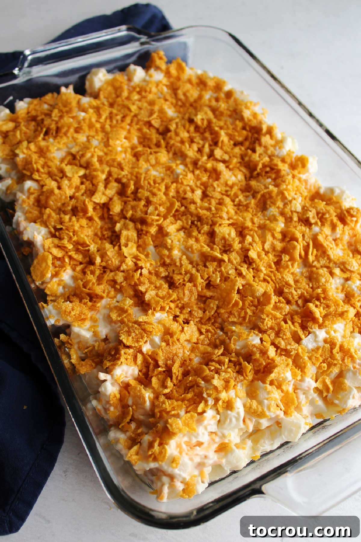 Cornflake Topping Applied Buttery cornflake mixture over potato mixture in pan, ready to go in oven.