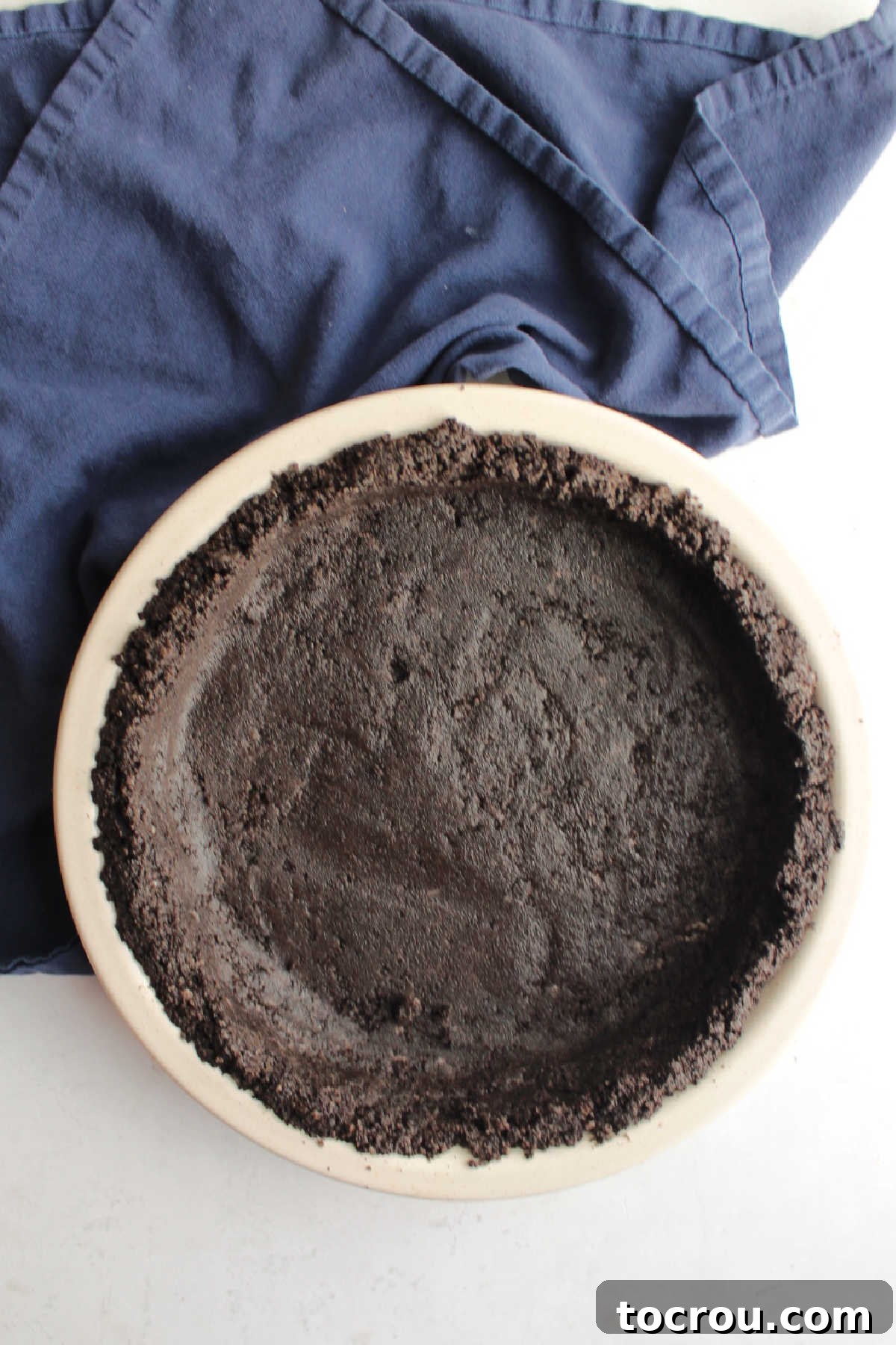 Prepared no-bake Oreo pie crust ready to be filled, showcasing its dark, inviting base.