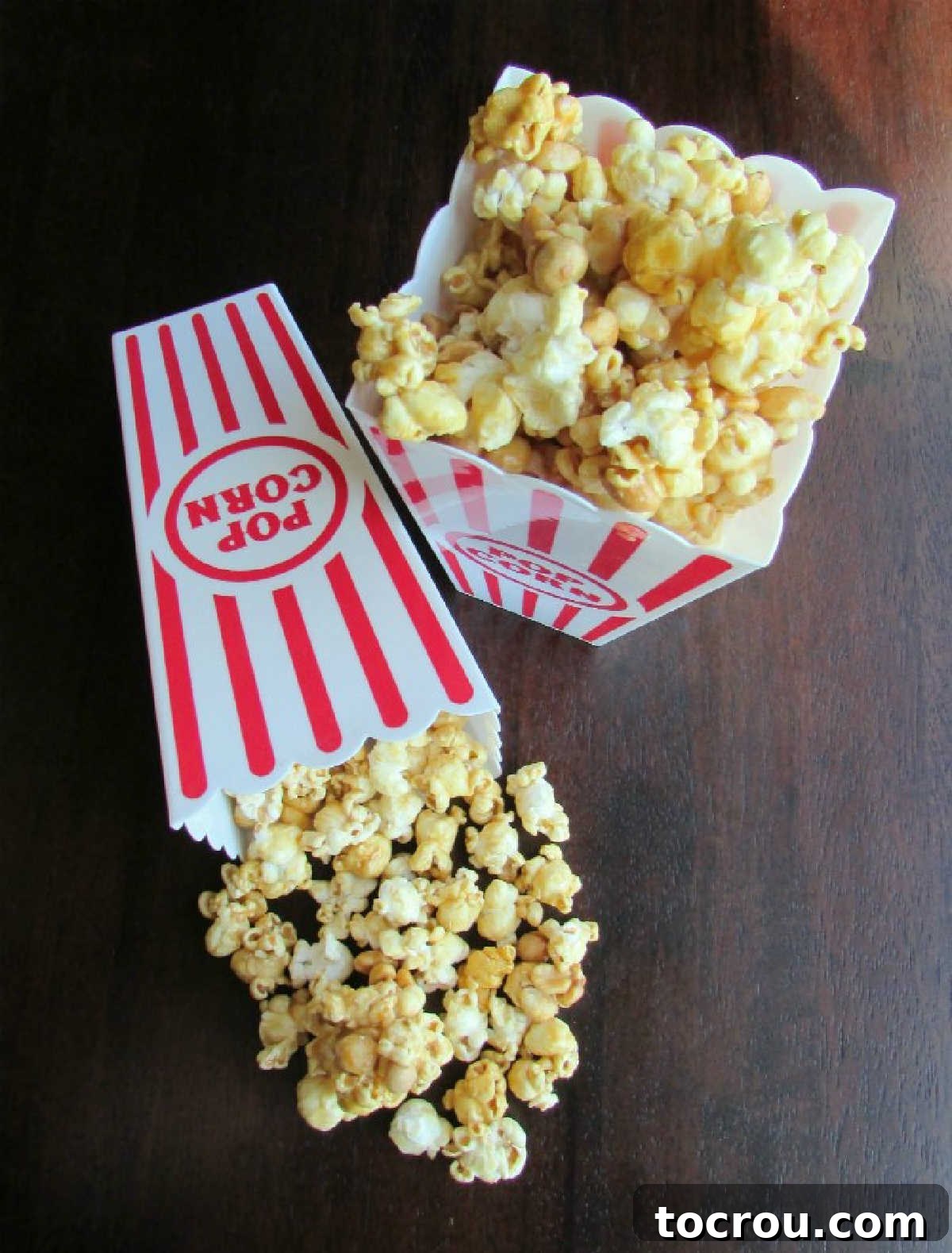 Movie-style popcorn containers overflowing with crunchy microwave caramel popcorn, generously mixed with peanuts and ready for serving.