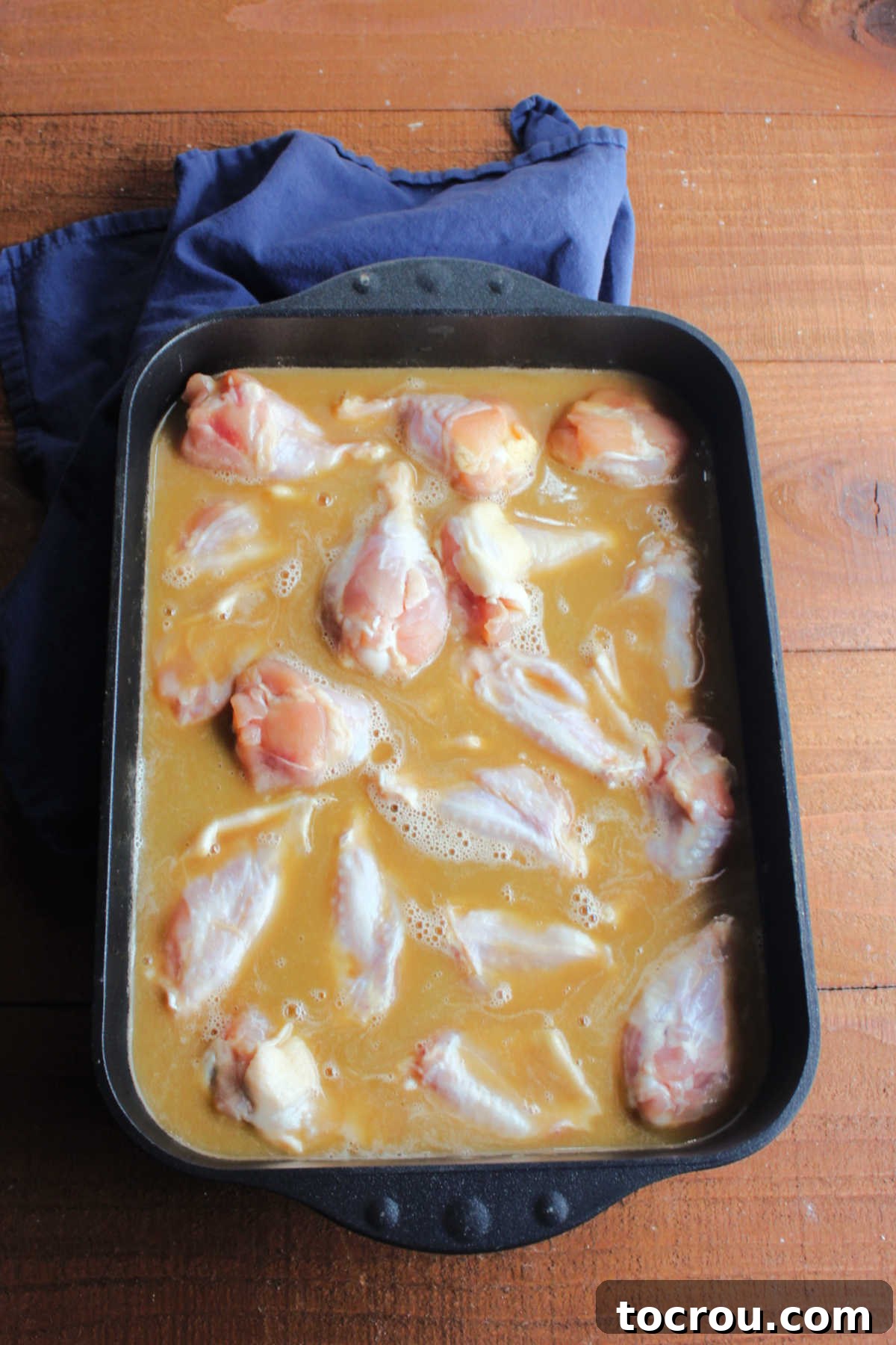 Sticky Caramelized Chicken Wings 3 Wings soaking in marinade made with soy sauce, brown sugar and butter.