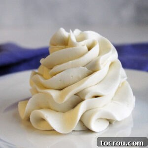 Ruffled swirl of white faux swiss meringue buttercream frosting.