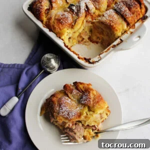 Plate of Monte Cristo Casserole with ham and cheese topped with powdered sugar.