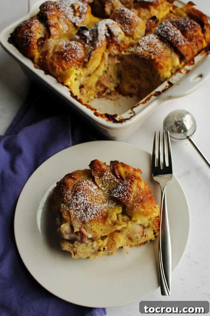 A delectable slice of Monte Cristo casserole, beautifully dusted with powdered sugar and ready for a delightful breakfast or brunch experience.