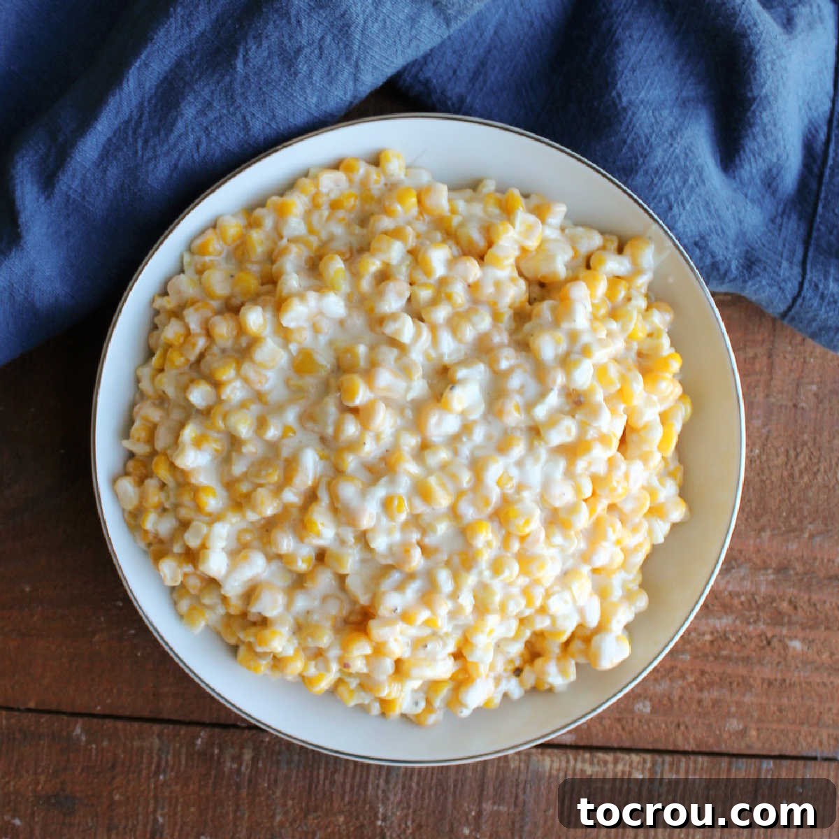 Crockpot Creamed Corn - A Rich and Creamy Side Dish A vibrant serving bowl filled with creamy, golden yellow slow cooker creamed corn, ready to be enjoyed as a delightful side dish.