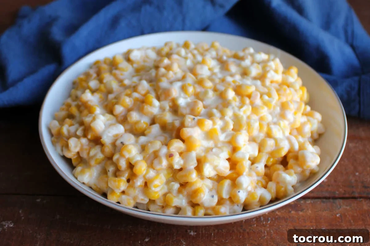 Luscious Slow Cooker Creamed Corn Texture A close-up view across a serving bowl of creamy corn, highlighting its luscious texture and the rich coating on each kernel.