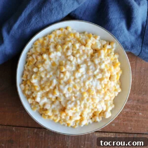 Slow Cooker Creamy Corn Serving bowl with creamy corn in cream cheese and butter mixture, ready to be served.
