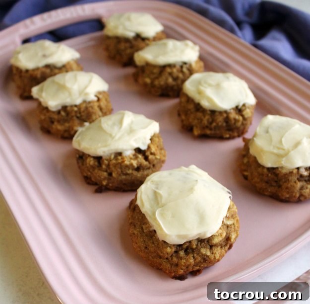 Frosted Banana Bread Cookies Platter Pink platter piled high with frosted whole wheat banana bread cookies, generously topped with maple cream cheese frosting.